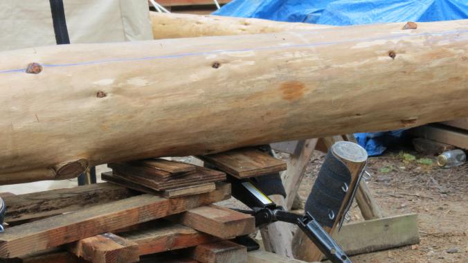 Jacking up the beam to level it on the saw bucks